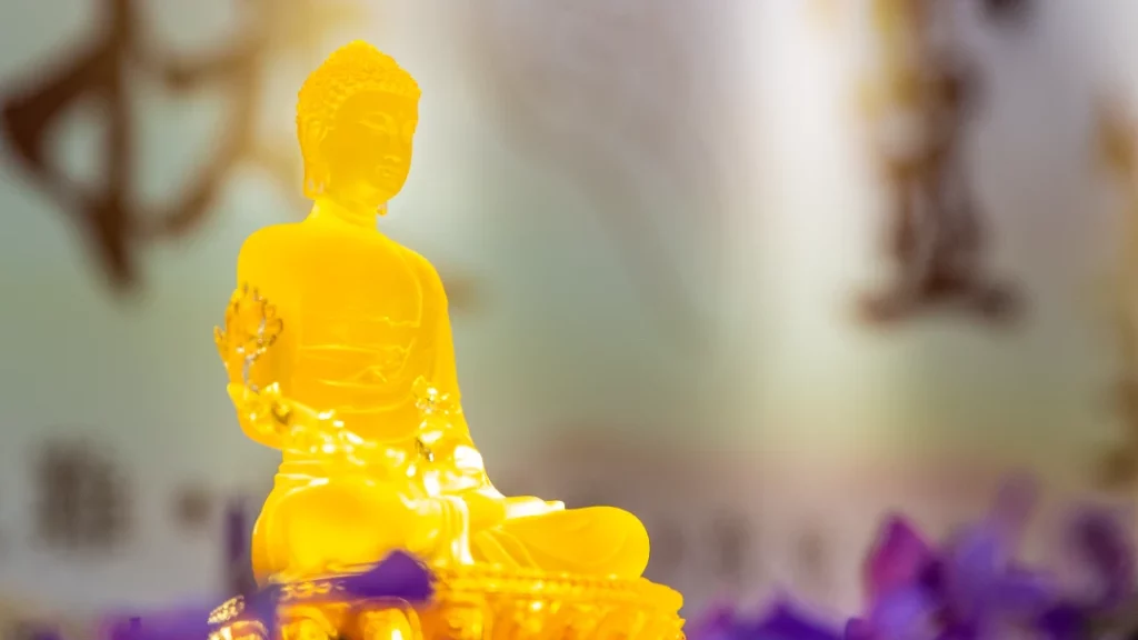A Medicine Buddha statue made of yellow glazed porcelain.