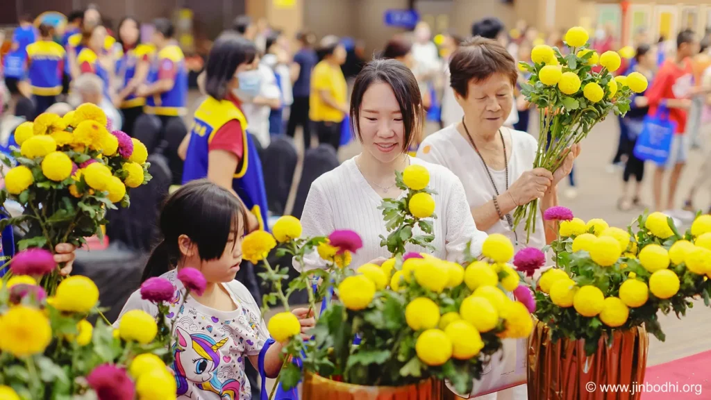 Participants offered flowers in front of the Earth Store Bodhisattva statue.  